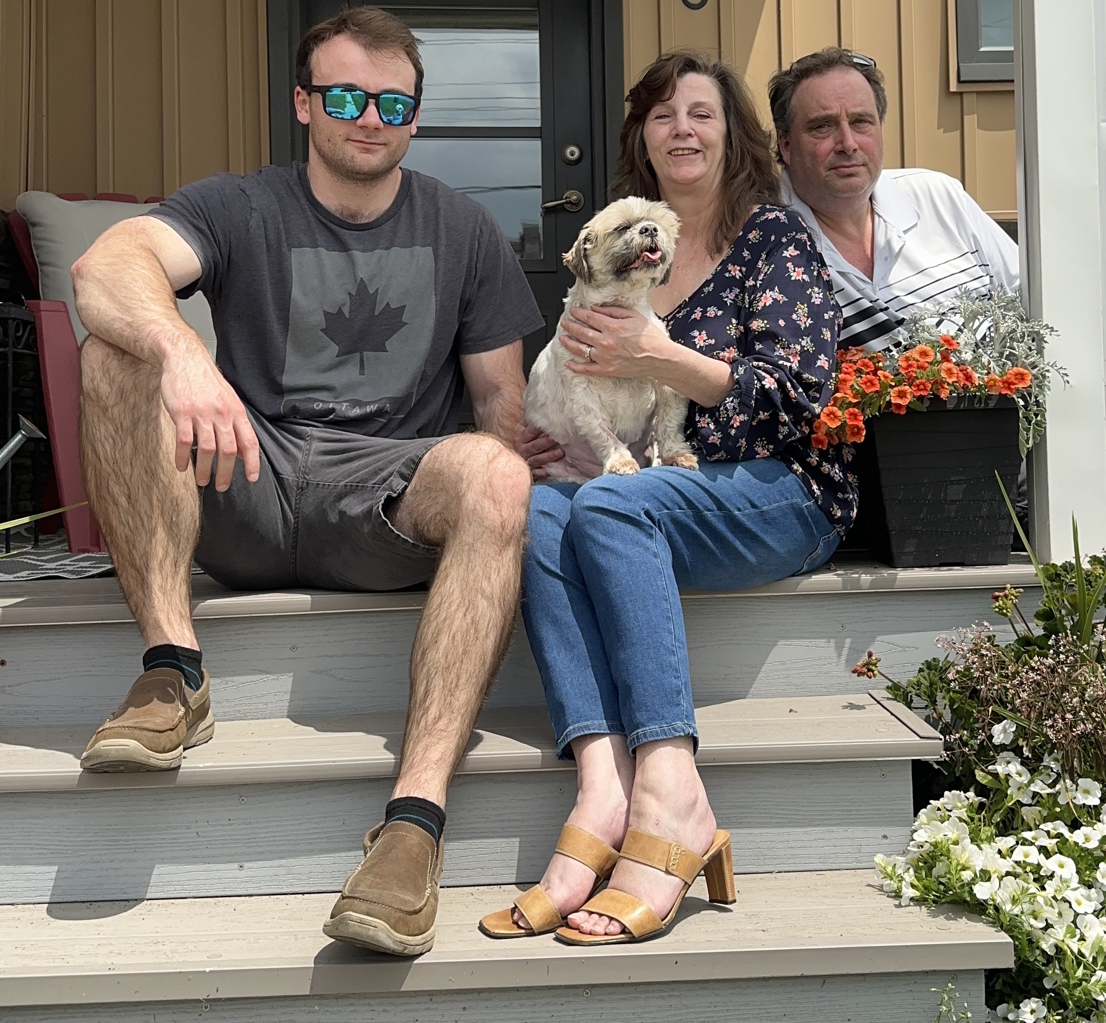 Jeremie, Lynn, and Zach Paulin on the front porch.